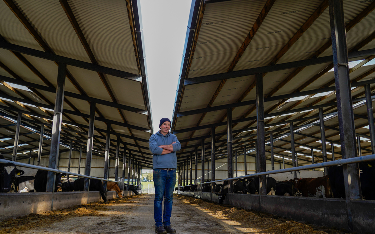 Gearoid Booth, Irish dairy farmer, standing in front of his dairy farm in Co. Laois